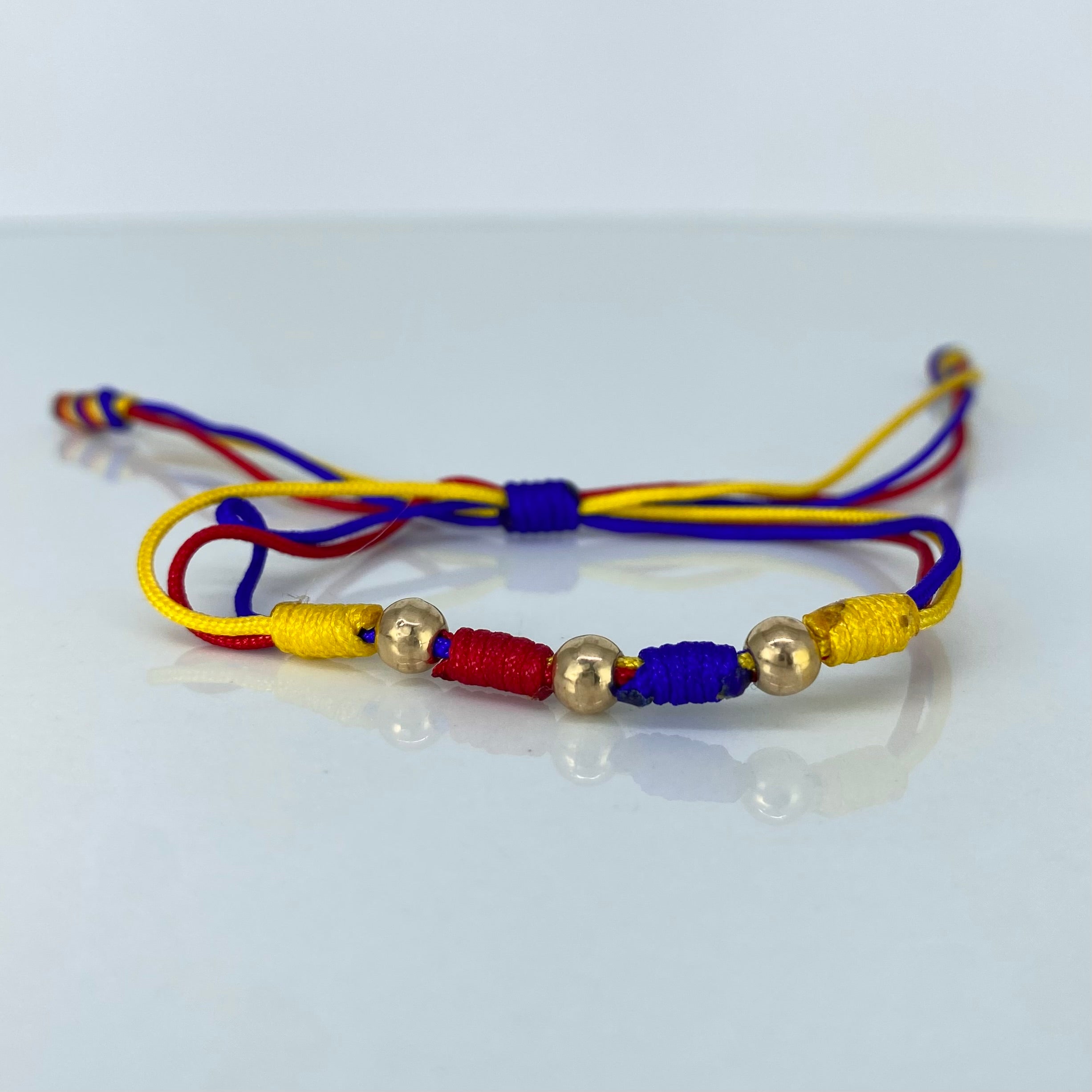 Pulsera tejida Colombia Bolas Lisas 3uni 5mm Hilo Colores Oro amarillo · 0,36 g