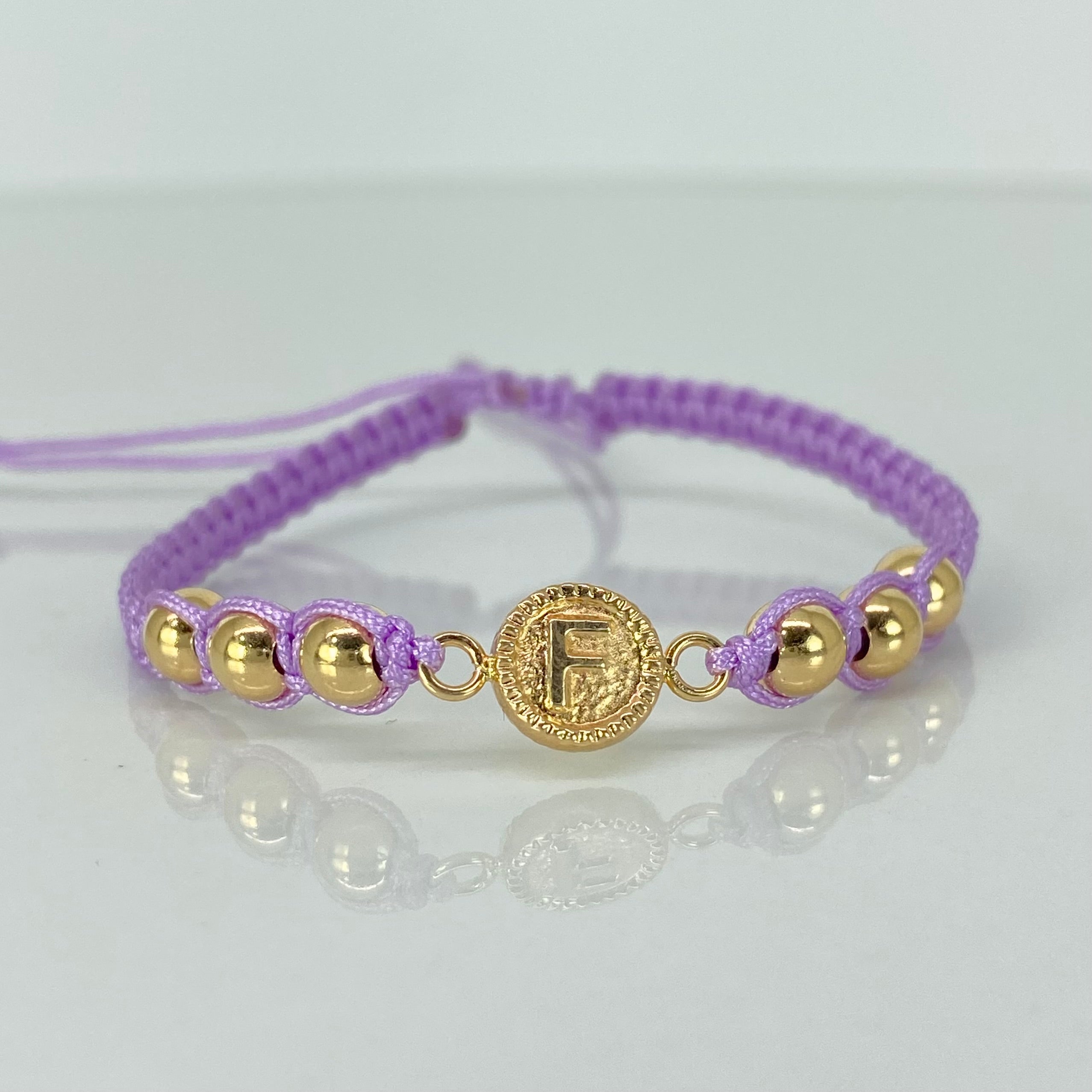 Pulsera tejida Herraje Letra F BL 6uni 5mm Hilo Lila Oro amarillo 18k · 1,02 g