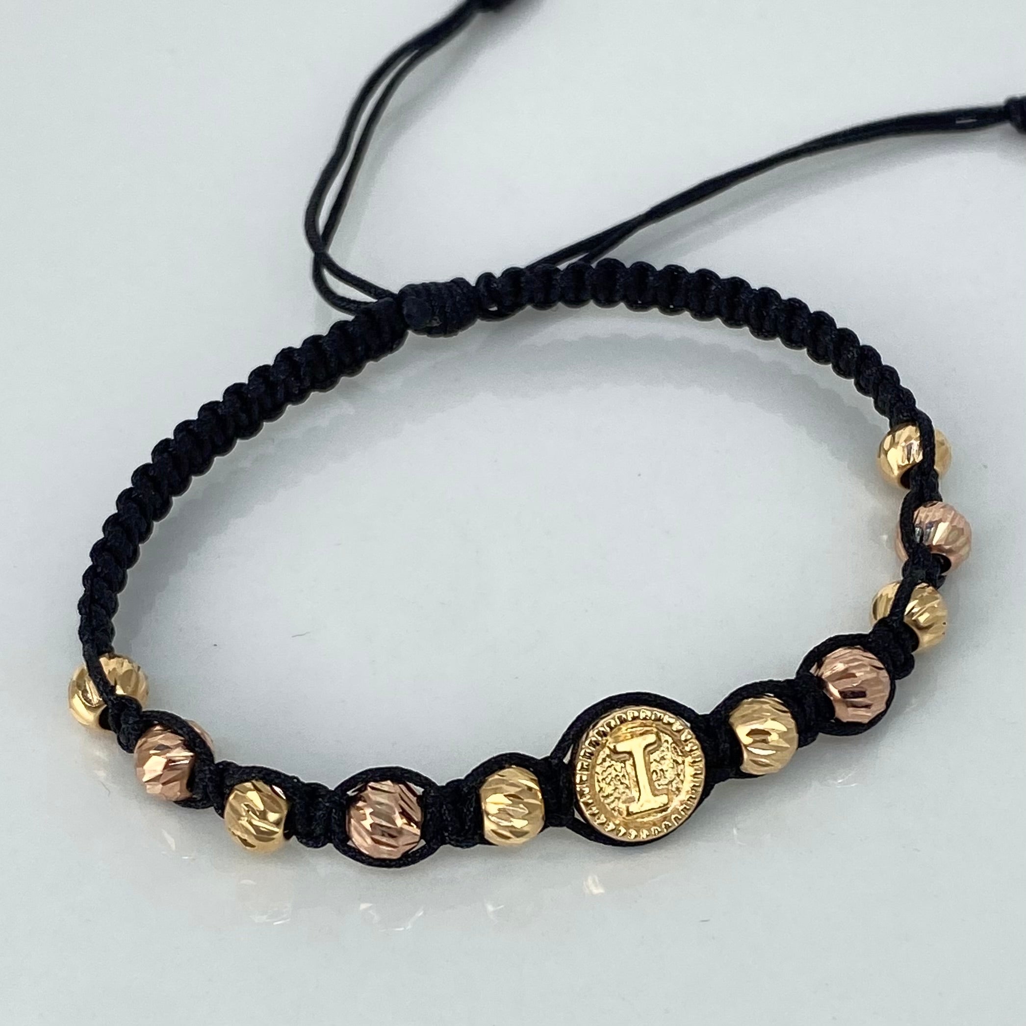 Pulsera tejida Herraje Letra I / BD 10uni 5mm / Hilo Negro Oro amarillo y Oro rosa 18k · 1,3 g